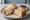 Monte Cristo: an illustration of ham, turkey, swiss cheese, egg and more on white bread.