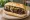 Morcilla Criolla: an illustration of morcilla and onion on baguette.