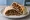 Moujadara Sandwich (ساندويش مجدرة): an illustration of rice and onion on pita.