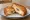 Mozzarella in Carrozza con Alici: an illustration of mozzarella, anchovy and egg on white bread.