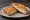 Mozzarella in Carrozza: an illustration of mozzarella and egg on white bread.