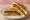 Mumbai Masala Sandwich: an illustration of butter, potato, onion, tomato and more on white bread.