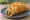 Nacho Cheese Chalupa: an illustration of beef, lettuce, tomato and sour cream on tortilla.