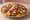 Nachos (Loaded): an illustration of potato chips, beef, cheese, jalapeño and more.