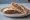 Nayyeh Sandwich (ساندويش نيء): an illustration of lamb, beef, onion, mint and more on pita.