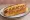 New England Hot Dog: an illustration of hot dog, butter and mustard on hot dog bun.