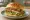 Oregon Hazelnut Chicken Sandwich: an illustration of chicken, butter, mustard and lettuce on brioche.