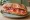 Pa amb Tomàquet Garni: an illustration of ham, tomato, olive oil and garlic.