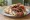 Paidakia se Pita (Παϊδάκια): an illustration of lamb, tomato, onion, tzatziki and more on pita.