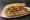 Palamut Ekmek: an illustration of onion, lettuce, tomato and lemon on bread.