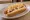 Pancho Completo: an illustration of sausage, mayonnaise, ketchup, mustard and more on hot dog bun.