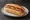 Pancho Común: an illustration of sausage, ketchup and mustard on hot dog bun.