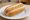 Pancho con Mostaza: an illustration of sausage and mustard on hot dog bun.