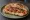 Pane Cunzato Catanese: an illustration of anchovy, tomato, olive oil and oregano.
