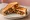 Paneer Chilli Sandwich: an illustration of pepper, onion and maggi seasoning sauce on white bread.