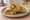 Paneer Kathi Roll: an illustration of onion on naan.