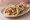 Paneer Tikka Naan Wrap: an illustration of yogurt and onion on naan.
