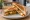 Paneer Tikka Sandwich: an illustration of yogurt and onion on white bread.