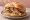 Panino al Porchetta: an illustration of porchetta, rosemary, garlic and pepper on kaiser roll.
