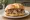 Panino con Abbacchio: an illustration of lamb on kaiser roll.