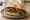 Panino con Bresaola della Valtellina: an illustration of beef, arugula, olive oil and lemon on kaiser roll.