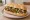 Panino con Falafel: an illustration of chickpeas, tahini, parsley and garlic on kaiser roll.