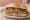 Panino con il Bollito: an illustration of beef, chicken and salsa verde on bread.