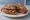 Panino con Kaminwurzen: an illustration of pork and sausage on rye bread.