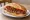 Panino con Lucanica: an illustration of pork, sausage and pepper on bread.