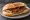 Panino con Luganega: an illustration of pork and sausage on bread.