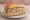 Panino con Nervetti: an illustration of beef, onion, olive oil and vinegar on bread.