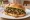 Panino con Ossobuco: an illustration of veal, lemon, garlic and parsley on bread.