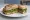Panino con Pesto Genovese: an illustration of basil, garlic, parmesan and olive oil.