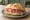 Panino con Prosciutto di San Daniele: an illustration of pork and prosciutto on kaiser roll.