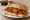 Panino con Ragù Napoletano: an illustration of beef, tomato, onion, garlic and more on bread.