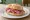 Panino con Salame Felino: an illustration of salami, pork, pepper and garlic on kaiser roll.