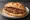 Panino con Salsiccia Calabrese: an illustration of sausage, pork and pepper on kaiser roll.