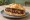 Panino con Salsiccia di Cavallo: an illustration of sausage, horse, pepper and garlic on kaiser roll.