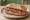 Panino con Soppressata: an illustration of salami, pork and pepper on bread.