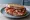 Panino con Speck Alto Adige: an illustration of speck, pork, pepper and butter on rye bread.