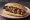 Panino con Stigghiola: an illustration of lamb, scallion, pepper and lemon on bread.