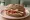 Panino Tirolese: an illustration of speck, pork, horseradish, butter and more on rye bread.