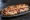 Panuozzo: an illustration of pork, mozzarella and ham on ciabatta.