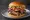 Pastrami Burger: an illustration of beef, pastrami, cheese, lettuce and more on burger bun.