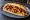 Patso Sucuklu: an illustration of sucuk and potato on bread.
