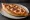 Peinirli me Loukaniko: an illustration of pork, sausage and cheese.