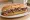 Pepito con Alioli: an illustration of beef, aioli and garlic on baguette.