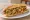 Philly-Style Chicken Sandwich: an illustration of chicken, american cheese, provolone, onion and more on hoagie roll.