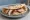 Piadina con Porchetta: an illustration of porchetta and pork.