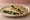 Piadina con Spinaci: an illustration of spinach, cheese and olive oil.
